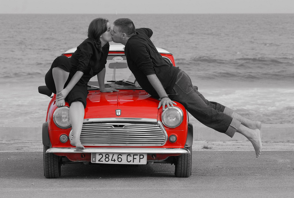 Couple kissing on red mini